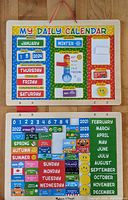 Photo of the full calendar hanging on a wooden surface, showing the magnetic calendar and various magnets.