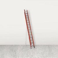 Ladder propped against wall showing full height and two sections extended