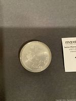Reverse side of the sealed 1973 Canada Silver 10 Dollar coin with map of Canada and Montreal 1976 Olympic Games text.