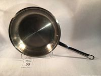 Top view of stainless steel pan showing the inside surface and handle attachment.