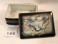 Open view of the trinket box showing interior and lid with dragonware design