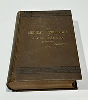 Front cover view showing brown cloth binding with gilt title and decorative borders