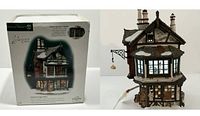 Photo of the lighted porcelain house alongside its original packaging box.