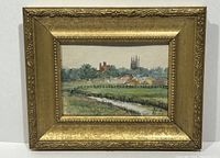 Frontal view of the framed watercolor landscape with water channel and buildings, gold frame