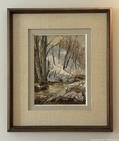 Full view of the framed oil painting showing the landscape scene and the wooden frame with linen mat.