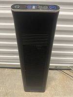 Front view of the Ionic Pro Platinum black tower air purifier showing vented front panel and top control panel.
