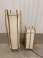 Front view of both lamps side by side showing bamboo frames and shades