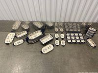 Full view of multiple ceramic bakeware pieces including rectangular trays, small square dishes, and muffin pan.