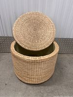 Top view of rattan wicker basket with lid off revealing light green cloth lining inside