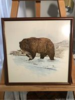 Full view of framed Glen Loates wildlife print showing brown bear with fish on snowy ground.