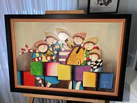 Front view of the framed painting showing the colorful children and musical instruments