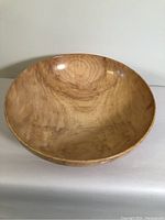 Front view of the lathe turned spalted birch wood bowl on plain surface, showing smooth polished interior and natural wood grain.