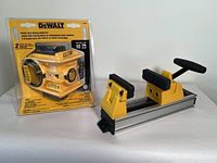 DeWalt door lock installation kit in original packaging alongside Stanley quick vise with yellow and black components on metal base.