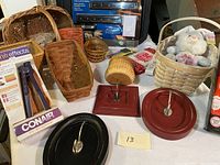 Overall lot contents showing baskets, wooden trays, plush toy, and boxed hair accessories
