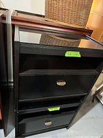 Pair of dark brown bedside tables with glass tops and drawers