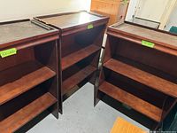 Photo showing three wooden shelving units side by side, displaying their shelving structure and surfaces