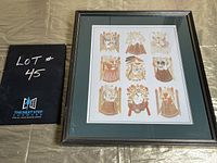 Photo of framed vintage Chinese paper cut folk art with nine traditional figures arranged in a 3x3 grid, featuring detailed cutouts in warm hues.