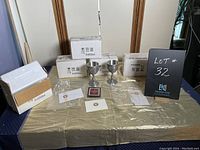 Six pewter goblets with original packaging and certification documents displayed on table.