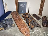 Overview of five masks laid out on a flat surface, showing variation in size, design, and material.