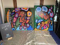 Both original Maurice DeLangis Woodland style paintings displayed side by side highlighting colors and composition.