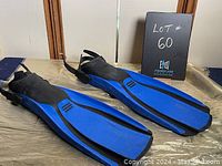 Pair of blue and black Genesis scuba fins shown from the top side with adjustable straps.