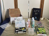 Full view of the Rapitest soil test kit contents including box, test tubes, liquids, color chart, instructions plus an Apera Instruments electronic pocket tester in carrying case lying on a gold cloth surface.