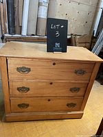Front view of vintage wooden low boy dresser with three drawers and brass handles, labeled Lot #3.