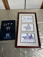 Framed triptych watercolour painting with three panels displaying horses and Native riders in motion, housed in a dark wood frame with matting.