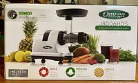 Box of Omega J8006 HDS Silver Slow Speed Nutrition System Juicer with product and branding visible