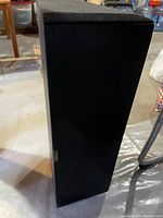 Front view of the Paradigm CC-350 center channel loudspeaker showing black fabric grille and cabinet shape.