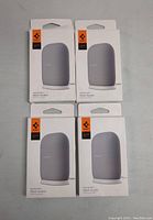 Four boxed Spigen Nest Audio Stands shown face up with front product images and branding visible.