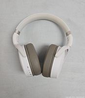 Top view of white SENNHEISER HD 450BT headphones showing padded band and ear pads in gray.