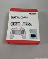 Front of the DOBE Controller Grip box, showing product image and branding. Compatible with left and right Nintendo Switch Joy-Con controllers.