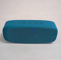 Blue Lenrue wireless Bluetooth speaker showing metal front grill with Lenrue logo and control buttons on top.