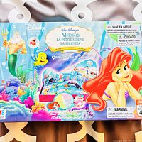 Box top featuring colorful artwork from Disney's The Little Mermaid with Ariel, King Triton, and Flounder, board game title, and warnings.