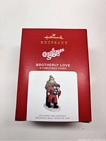 Photo of the original Hallmark red box packaging for 'Brotherly Love' ornament with A Christmas Story branding and image of the ornament on front.