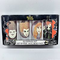 New in box Hocus Pocus 4 glassware set with caricatures of Sanderson sisters visible through packaging window