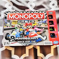 Front of Monopoly Gamer Mario Kart Edition box showing Mario, Luigi, Princess Peach, and Toad racing characters.