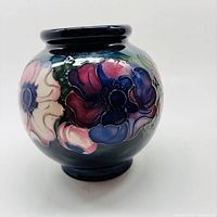 Front side view showing the round shape and floral design on vase