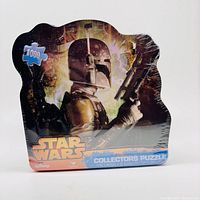 Front of sealed Star Wars 1000 piece collectors puzzle box featuring Boba Fett with a fiery background.