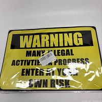 Photo showing full yellow warning sign with black text and slight bend in middle left area