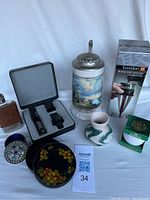 Photo of lot showing German beer stein with pewter lid, boxed Kuradorn wine decanter aerator, Nemadji vase, leather-covered Scotch flask, decorative bowl and jeweled trinket box