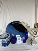 Full lot view showing all items including eye washer, bottles, ceramic dish, lamp, and fish coat hooks.