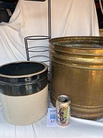 Photo showing all three items side by side with soda can for scale: large ceramic crock, brass planter, and black metal paper holder.
