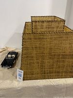 Two tier MCM fiberglass lampshade with visible stitching, shown with model car beside it