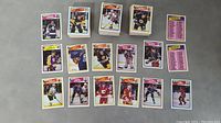 Photo showing multiple hockey cards laid out including a stack and individual cards showing players in NHL uniforms.