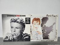 Front covers of two David Bowie LP albums showing 'ChangesOneBowie' with Bowie black and white photo and 'Scary Monsters' illustrated cover.