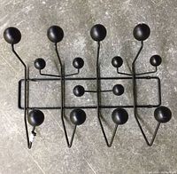 Top view of the black metal coat hanger showing all spherical ball ends and hook layout.