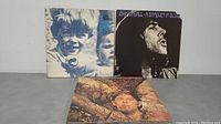 Front view of all three John Mayall LP vinyl albums laid flat showing cover artwork featuring portraits and blues themes.