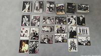 Laid out selection of black and white trading cards showing The Beatles and Elvis Presley in various portraits and group shots.